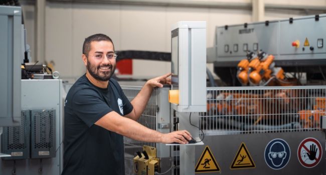 Employees working at a machine